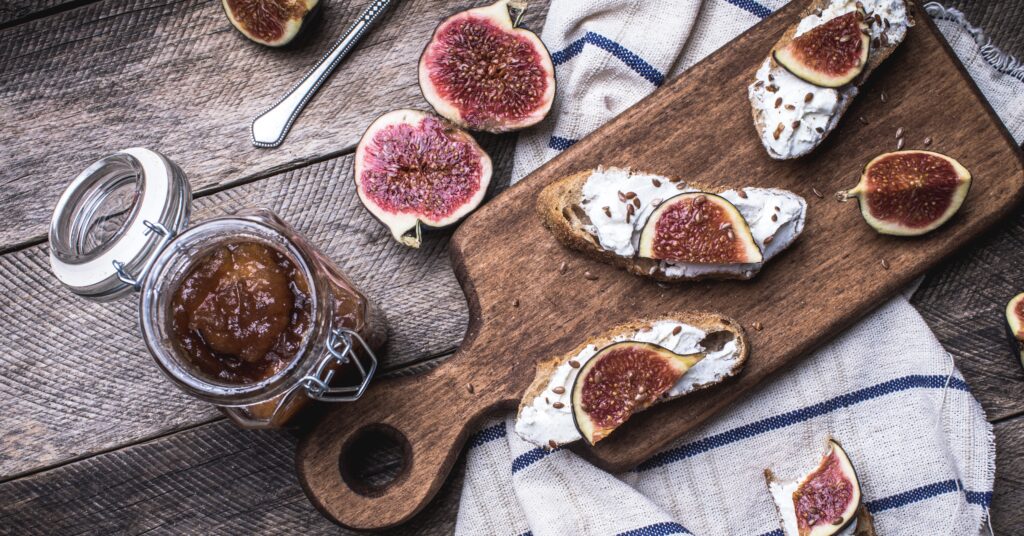 Figs on a rustic board with Bruschetta and fig jam