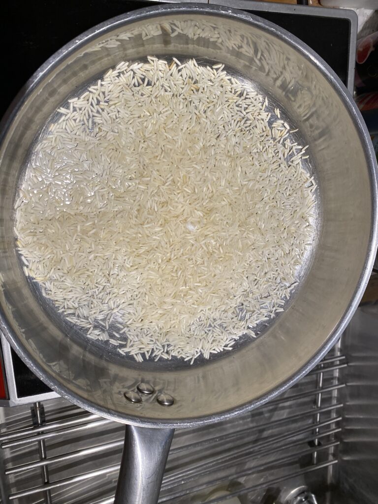 saute rice before cooking - basmati rice about to toast in a saute pan