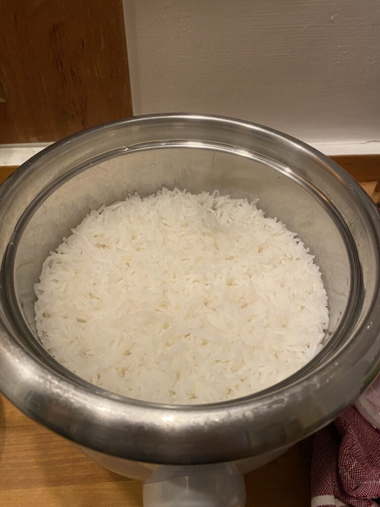 crunchy rice in a stainless steel rice cooker pot